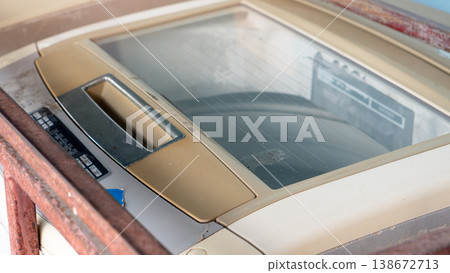 Top loading washing machine lid. The transparent glass lid allows a view of the internal workings of the system. A blurry image of the metal barrier separating the washing machine. Top loading washing machine lid. The transparent glass lid allows a view of the internal workings of the system. A blurry image of the metal barrier separating the washing machine. 138672713