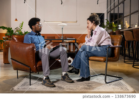 Man looking at sad woman client during session Man looking at sad woman client during session 138673690