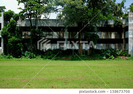 一座被熱帶樹木覆蓋的廢棄混凝土建築，東南亞的城市廢墟。 138673708