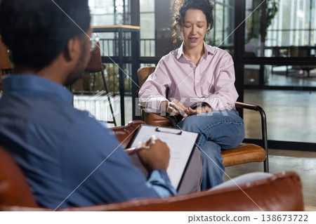 Woman talking during consultation with man Woman talking during consultation with man 138673722