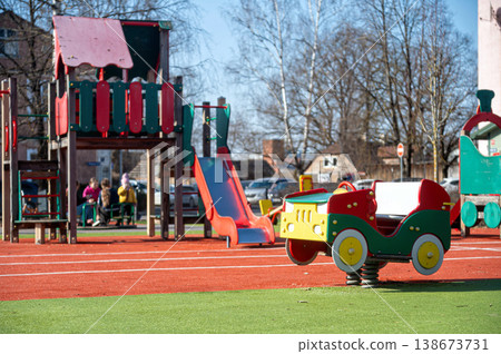 Children play on equipment in a park during a sunny day in the afternoon Children play on equipment in a park during a sunny day in the afternoon 138673731