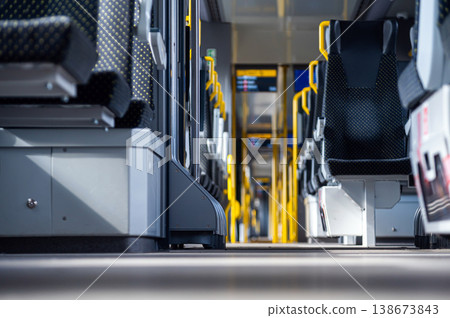 Inside a train showing empty seats and clean aisles during the day Inside a train showing empty seats and clean aisles during the day 138673843
