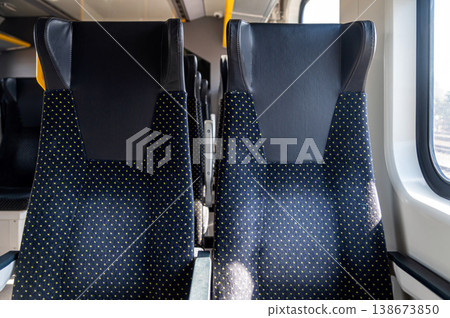 Train seats in a coach showing a view of the interior in daylight Train seats in a coach showing a view of the interior in daylight 138673850