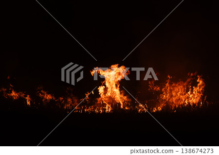 Burning fire flames isolated on dark background with smoke, dramatic wildfire effect, high contrast fire texture for overlay and design use. Burning fire flames isolated on dark background with smoke, dramatic wildfire effect, high contrast fire texture for overlay and design use. 138674273