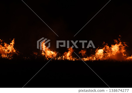 Burning fire flames isolated on dark background with smoke, dramatic wildfire effect, high contrast fire texture for overlay and design use. Burning fire flames isolated on dark background with smoke, dramatic wildfire effect, high contrast fire texture for overlay and design use. 138674277