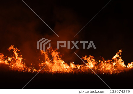 Burning fire flames isolated on dark background with smoke, dramatic wildfire effect, high contrast fire texture for overlay and design use. 138674279