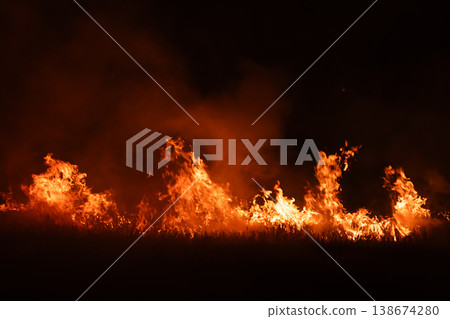 Burning fire flames isolated on dark background with smoke, dramatic wildfire effect, high contrast fire texture for overlay and design use. Burning fire flames isolated on dark background with smoke, dramatic wildfire effect, high contrast fire texture for overlay and design use. 138674280