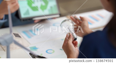 Renewable energy brainstorming with light bulb and charts Renewable energy brainstorming with light bulb and charts 138674501