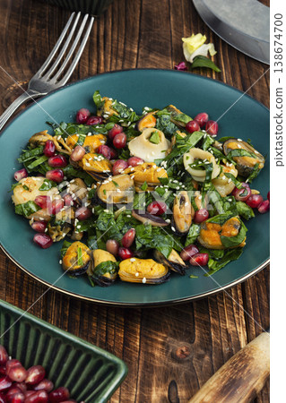 Healthy seafood salad with shrimp mussels squid and pomegranate 138674700