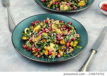 Seafood salad with shrimp, mussels, squid and pomegranate 138674702