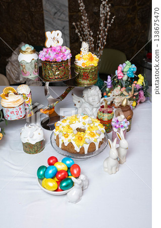 Abundant Easter Table with Decorated Kulichi, Bunny Figurines and Colored Eggs Abundant Easter Table with Decorated Kulichi, Bunny Figurines and Colored Eggs 138675470