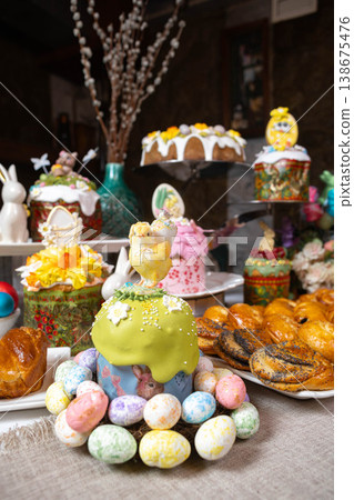 Easter Table: Kulichi in Painted Molds, Decorated Eggs, Pastries, and Figurine Chicks  138675476