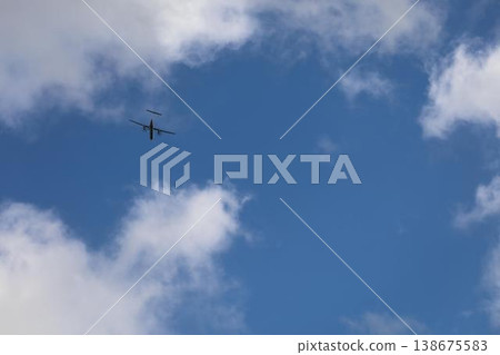 An airplane flying into the blue sky 138675583