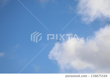 An All Nippon Airways (ANA) propeller passenger plane flies through the blue sky towards New Chitose Airport. An All Nippon Airways (ANA) propeller passenger plane flies through the blue sky towards New Chitose Airport. 138675584
