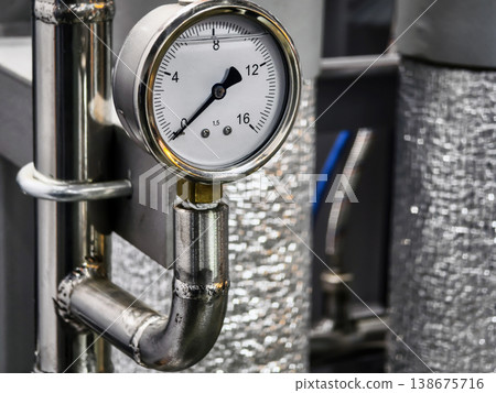 Pressure gauge on industrial equipment showing measurement in manufacturing facility Pressure gauge on industrial equipment showing measurement in manufacturing facility 138675716