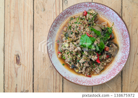 Authentic Thai Beef Larb Salad Laab Neua Spicy Ground Meat Dish on Wooden Table with Copy Space Authentic Thai Beef Larb Salad Laab Neua Spicy Ground Meat Dish on Wooden Table with Copy Space 138675972