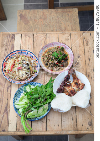 Authentic Thai Isan Food Set Som Tum Papaya Salad, Beef Larb, Grilled Chicken and Sticky Rice Authentic Thai Isan Food Set Som Tum Papaya Salad, Beef Larb, Grilled Chicken and Sticky Rice 138675980