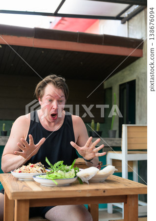 Shocked Man Reacting to Spicy Thai Food Som Tum Papaya Salad Vertical Portrait Copy Space Shocked Man Reacting to Spicy Thai Food Som Tum Papaya Salad Vertical Portrait Copy Space 138676094