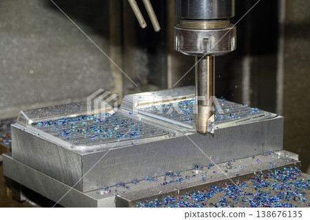 Close-up of high-temperature metal chips generated during a heavy-duty CNC milling roughing process 138676135
