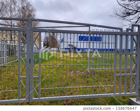 On an autumn day, a gray fence with raindrops. On an autumn day, a gray fence with raindrops. 138676647