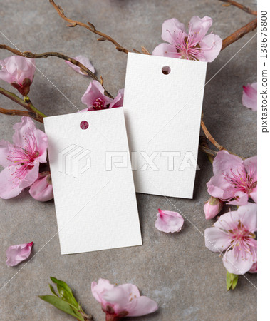 Spring blank gift tags mockup with pink cherry blossoms and twigs on grey stone, copy space 138676800