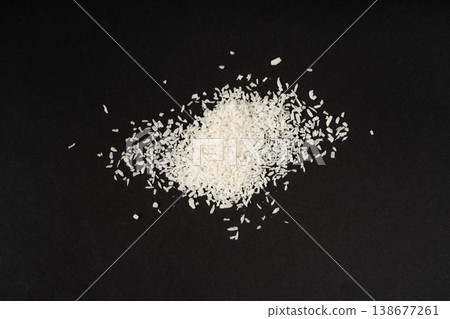 Grated coconut powder. Dry coco flakes pile, shredded desiccated coconut, tropical fruit chips Grated coconut powder. Dry coco flakes pile, shredded desiccated coconut, tropical fruit chips 138677261