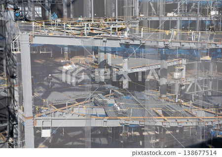 Floor construction work involving laying deck plates on steel frames; ramp structure under construction (6) 138677514