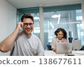Expert Meticulously Assessing Spreadsheet Metrics With Colleague Present In Calm Work Environment 138677611
