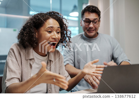 Woman Reacts Happily To Surprise. Woman Shows Excitement With Animated Gestures During Online Discovery Woman Reacts Happily To Surprise. Woman Shows Excitement With Animated Gestures During Online Discovery 138677612