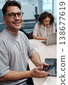 Individual Multitasking With Phone And Computer During Routine Office Activities In Workspace 138677619