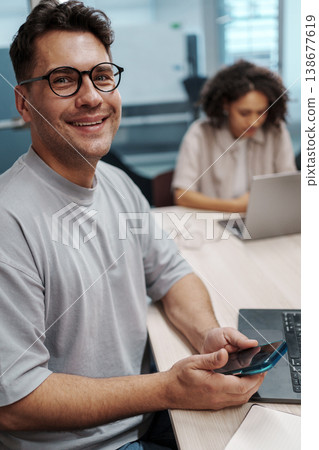 Individual Multitasking With Phone And Computer During Routine Office Activities In Workspace Individual Multitasking With Phone And Computer During Routine Office Activities In Workspace 138677619