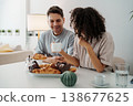Casual Morning Scene With Two Individuals Savoring Baked Goods And Engaging In Lighthearted Conversation 138677625