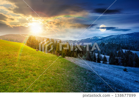 mountain scenery with coniferous forest. day meet night. sun and moon over countryside landscape with grassy fields and rolling hills. springtime rural area under cloudy sky. epic outdoor adventure 138677899