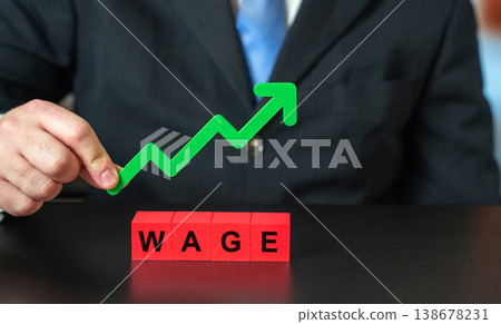Salary increase, profit growth, financial stability, business success, higher earnings and economic growth in finance and corporate settings. Blocks with the word Wage and a green upward arrow Salary increase, profit growth, financial stability, business success, higher earnings and economic growth in finance and corporate settings. Blocks with the word Wage and a green upward arrow 138678231