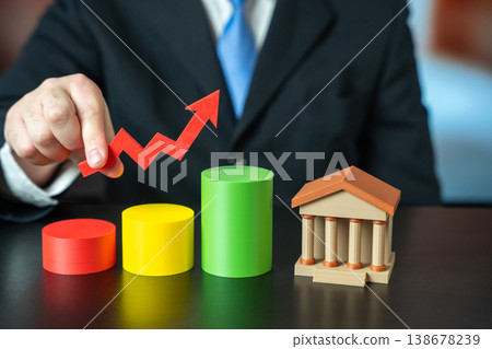Bank or government buildings with an upward growth chart in man hands Bank or government buildings with an upward growth chart in man hands 138678239