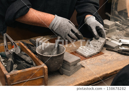Craftsman working with molds at festival market stall in Berlin 138678282