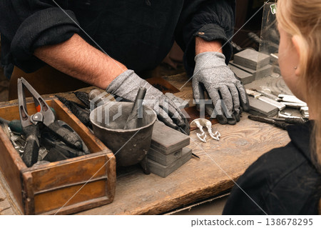 Craftsman demonstrating mold work at festival stall in Berlin 138678295