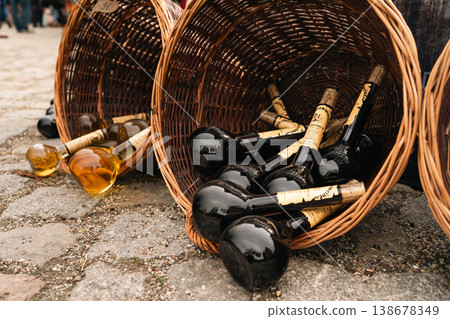 Dark glass bottles in wicker baskets at festival market in Berlin 138678349