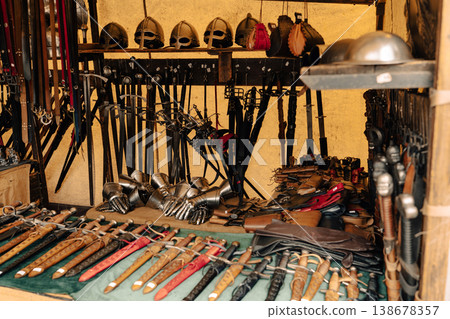Medieval weapons and helmets at festival market stall in Berlin 138678357