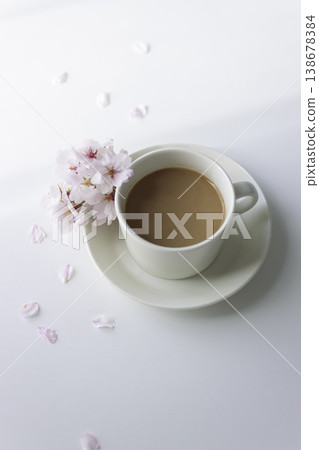 A spring tea time with cherry blossoms and café au lait; a vertical composition with plenty of white space. A spring tea time with cherry blossoms and café au lait; a vertical composition with plenty of white space. 138678384