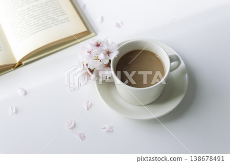 A springtime reading session with cherry blossoms, café au lait, and a book; a gentle tea time against a white background. A springtime reading session with cherry blossoms, café au lait, and a book; a gentle tea time against a white background. 138678491
