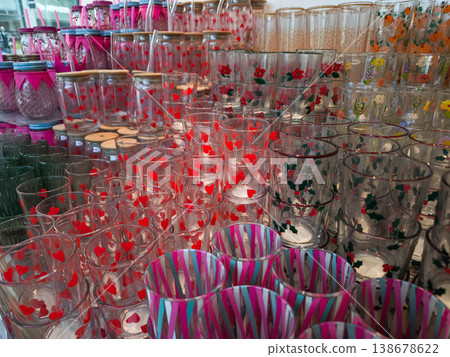 Colorful drinking glasses with festive designs filling a store shelf in prague Colorful drinking glasses with festive designs filling a store shelf in prague 138678622