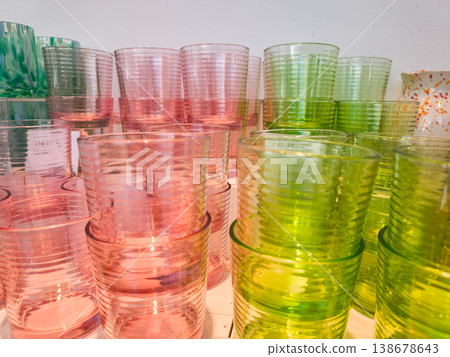 Colorful ribbed drinking glasses stacked on shelf in prague store 138678643