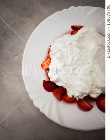 Fresh strawberries topped with fluffy whipped cream dessert for a delightful treat concept. copy space Fresh strawberries topped with fluffy whipped cream dessert for a delightful treat concept. copy space 138678706