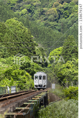 Miyazaki Prefecture, Nichinan City, Kitago Town, Taninojo Tunnel and the Nichinan Line Umisachi Yamasachi running through the fresh greenery. 138679147