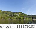 The Umisachi Yamasachi train on the Nichinan Line is traveling across the Hirotogawa Railway Bridge in Fukamidori, Kitago-cho, Nichinan City, Miyazaki Prefecture. 138679163