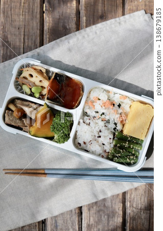 A healthy Japanese bento box using a lunch box with an integrated divider. A healthy Japanese bento box using a lunch box with an integrated divider. 138679185