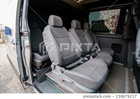 Interior View of Empty Passenger Seats in a Modern Grey Utility Van with Quilted Upholstery and Natural Light Interior View of Empty Passenger Seats in a Modern Grey Utility Van with Quilted Upholstery and Natural Light 138679217