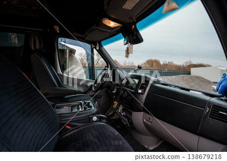 Interior View of Commercial Delivery Van Dashboard and Driver Seat with Outdoor Construction Site Background 138679218