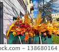 Umbrella and artificial autumn leaves decor near the boutique 138680164